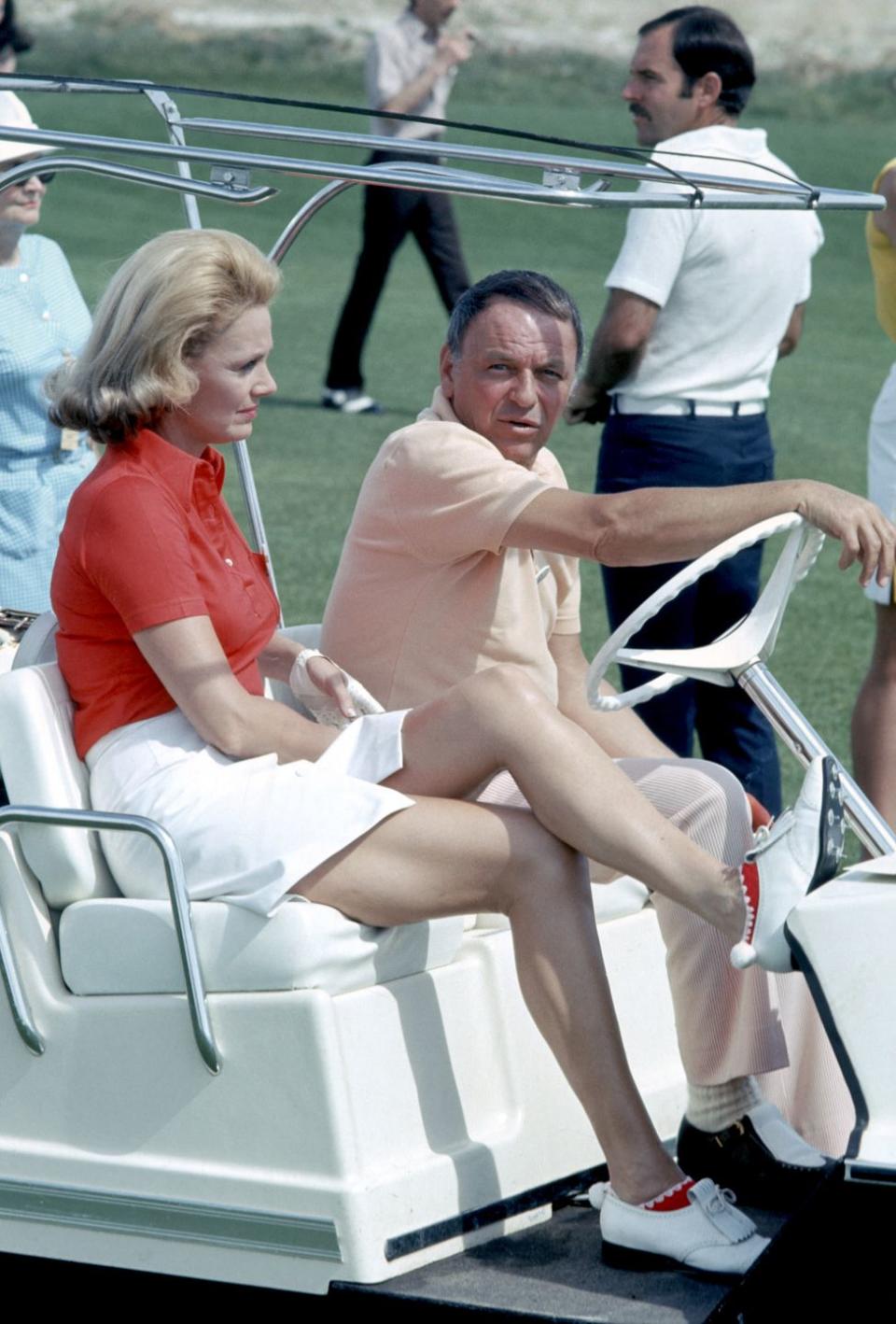 <p>Frank Sinatra enjoys a round of golf at a charity tournament in Palm Springs with girlfriend (and future wife) Barbara Marx in 1971. </p>