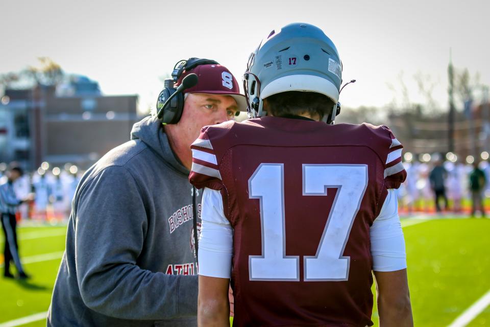 Bishop Stang head coach Dennis Golden lets his quarterback Noah Grigson know what he wants run during the third quarter of their Thanksgiving Day game vs. Bishop Feehan.