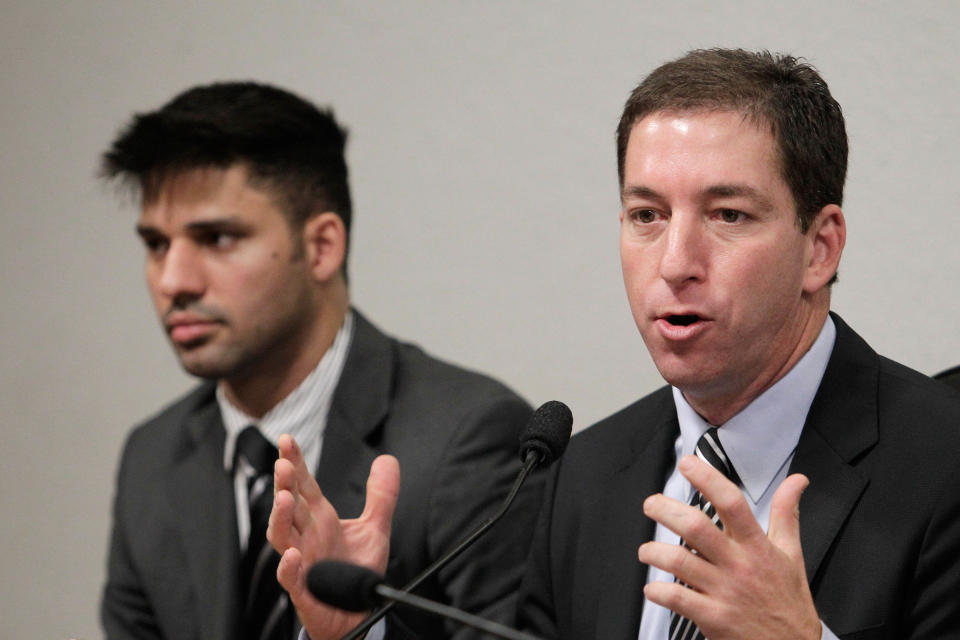 FILE- In this Oct. 9, 2013 file photo, American journalist Glenn Greenwald, right, speaks to a congressional committee investigating reports based on documents, leaked by former National Security Agency contractor Edward Snowden, at Congress in Brasilia, Brazil. Greenwald is among four journalists who reported on the extent of the National Security Agency’s secret surveillance based on documents leaked by Snowden, who are among the winners of the 65th annual George Polk Awards in Journalism's National Security Award. At left his Greenwald's partner David Miranda. (AP Photo/Eraldo Peres, File)