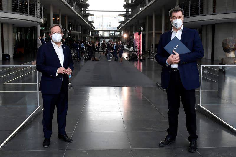 Armin Laschet and Markus Soder pose for photographers after a news conference in Berlin