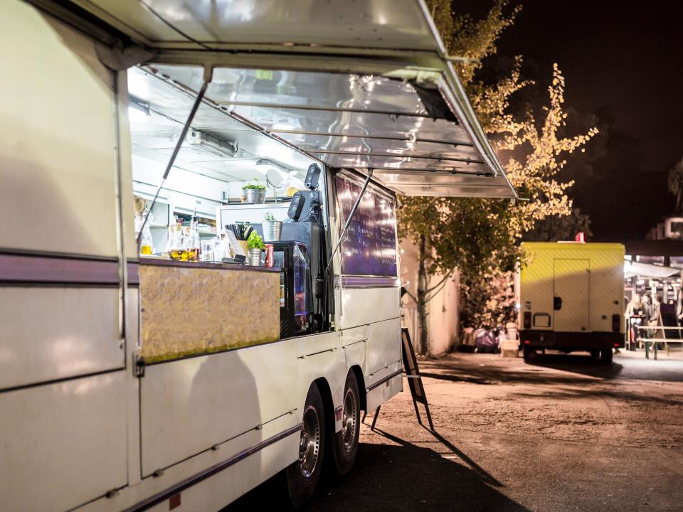 a food truck with its window open at night