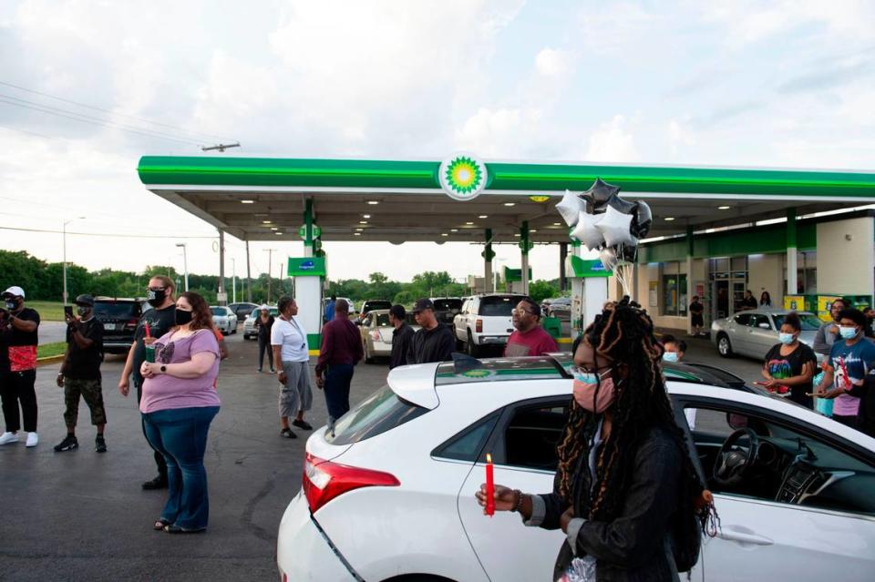 Members of the community gather for a vigil, Wednesday, June 2, 2021 at 63rd Street and Prospect Avenue in Kansas City where Malcolm Johnson, 31, was fatally shot by a police officer in March.