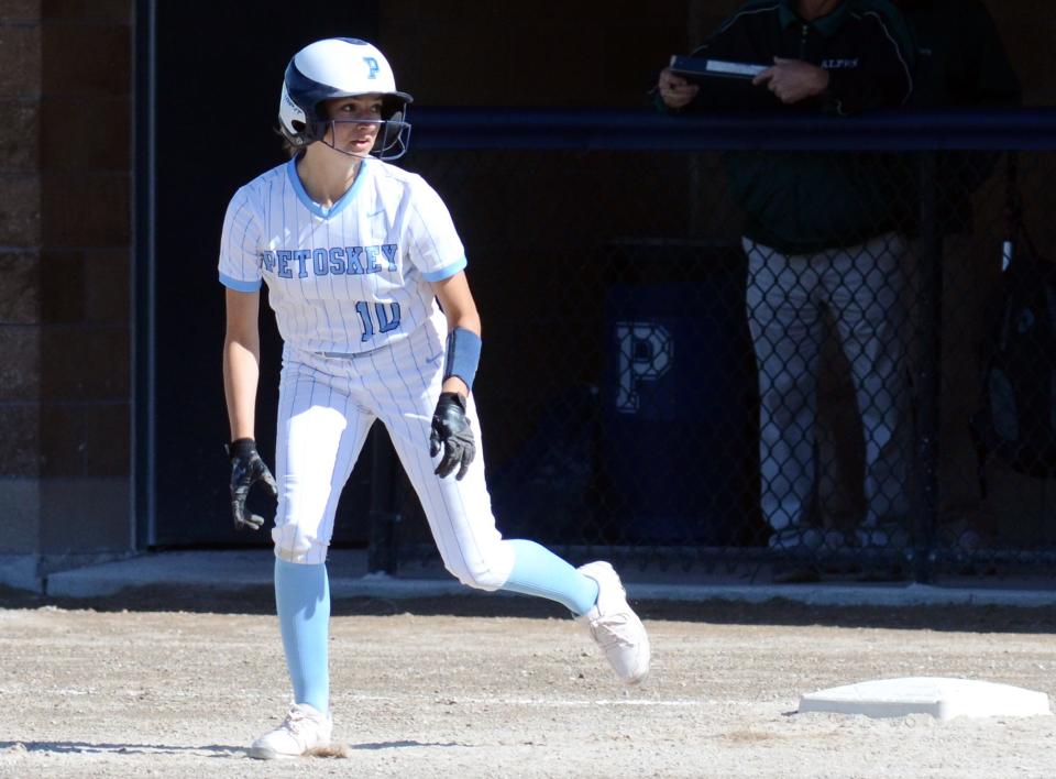 Petoskey senior Raija Gross watches the pitch as she takes off from first base against Alpena Tuesday.