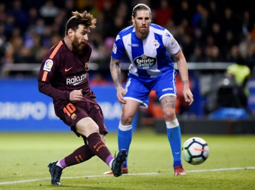 Lionel Messi scored two late goals to end Deportivo's resistance and wrap up the La Liga title