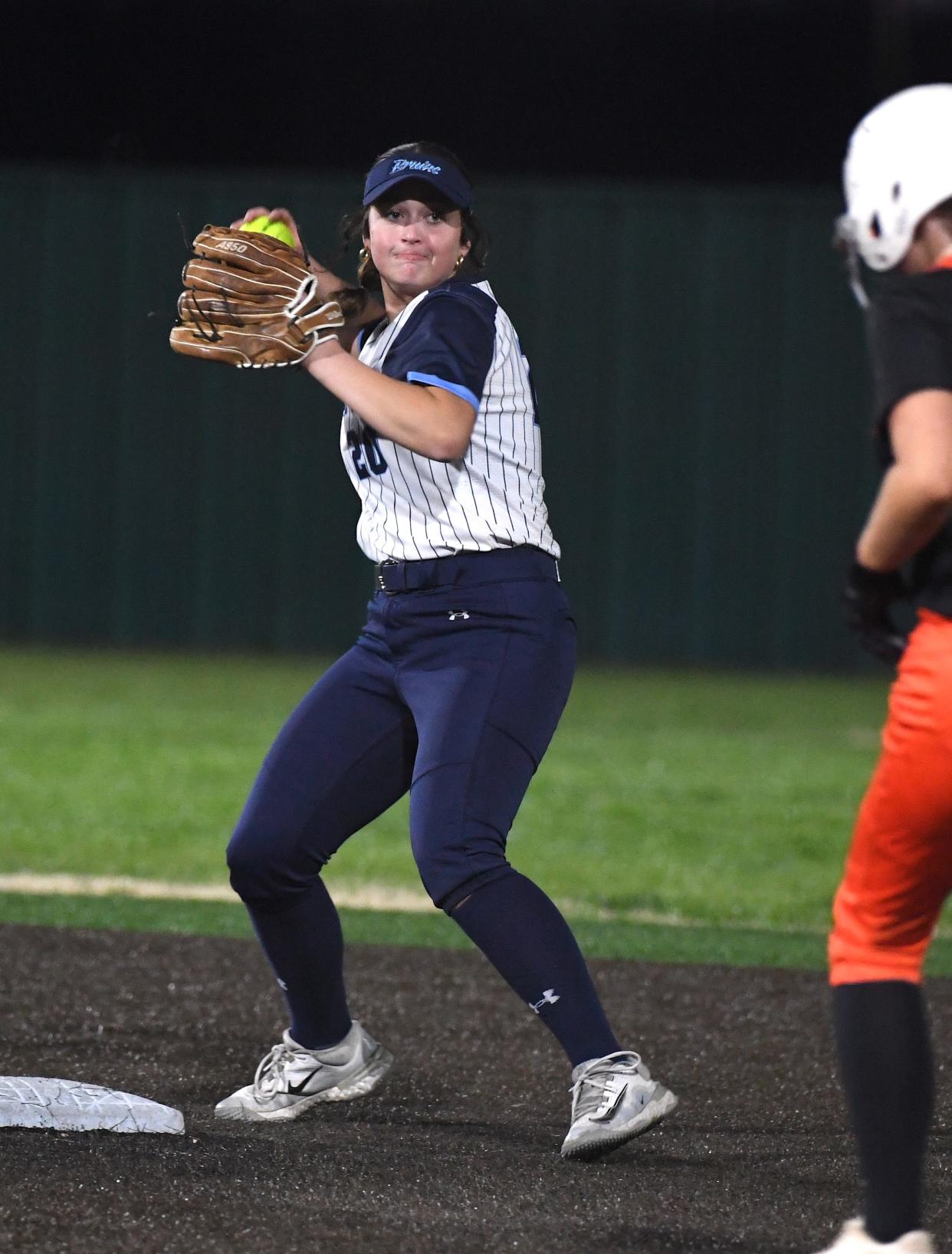 Bartlesville High School's Lola Redington (20) looks to turn a double play during slowpitch softball action in Bartlesville earlier in the season.