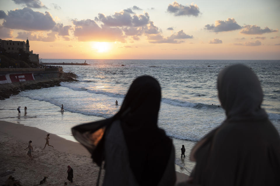 In this Monday, Sept. 23, 2019 photo, Two Israeli Arab women overlook the Mediterranean sea, in the mixed Arab and Jewish city of Jaffa, near Tel Aviv, Israel. Electoral gains made by Arab parties in Israel, and their decision to endorse one of the two deadlocked candidates for prime minister, could give them new influence in parliament. But they also face a dilemma dating back to Israel's founding: How to participate in a system that they say relegates them to second-class citizens and oppresses their Palestinian brethren in Gaza and the occupied West Bank. (AP Photo/Oded Balilty)