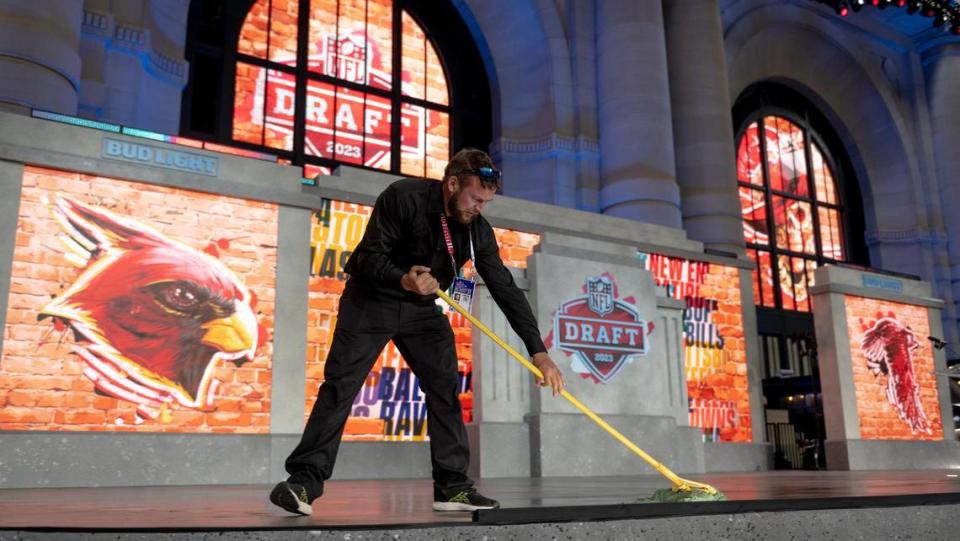 Wayne Byler mops the stage before the start of the NFL Draft outside of Union Station on Thursday, April 27, 2023, in Kansas City.