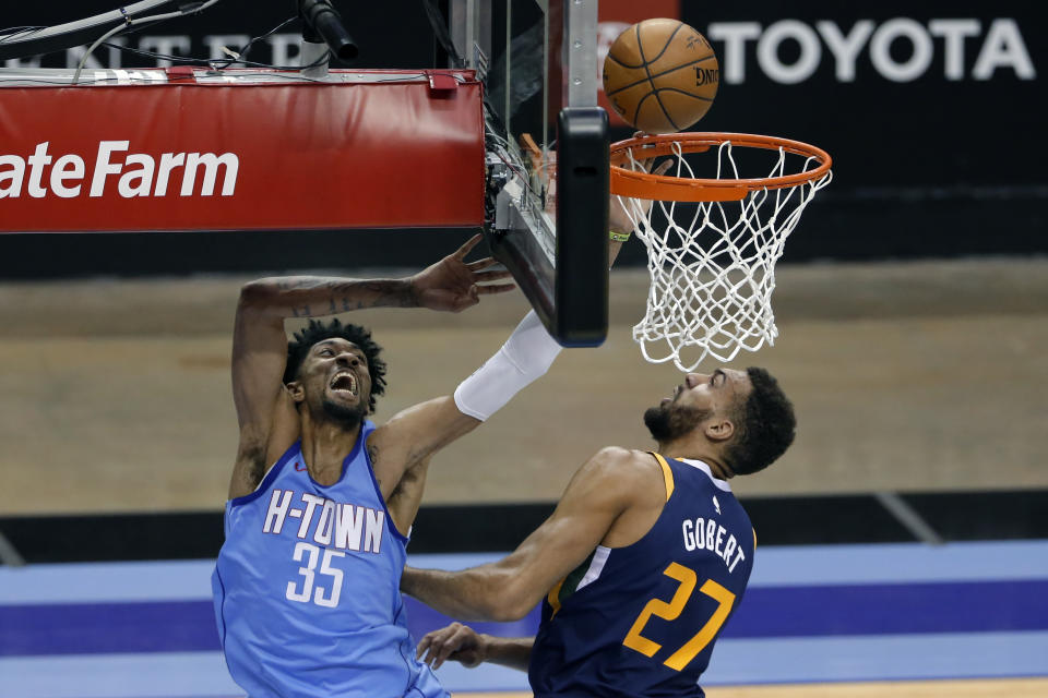 Houston Rockets center Christian Wood (35) puts up a shot past Utah Jazz center Rudy Gobert (27) during the first half of an NBA basketball game Wednesday, April 21, 2021, in Houston. (AP Photo/Michael Wyke, Pool)