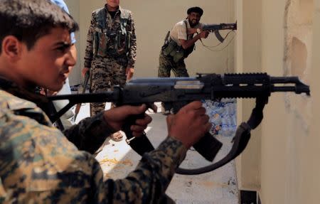 Members of the Syrian Democratic Forces try to locate Islamic State's sniper in Al Senaa, a district of Raqqa, Syria, August 10, 2017. REUTERS/Zohra Bensemra