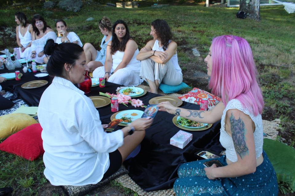 While the goddesses ate their food and talked among themselves, Young went around giving oracle cards to each woman at the Saturday, July 30 picnic.