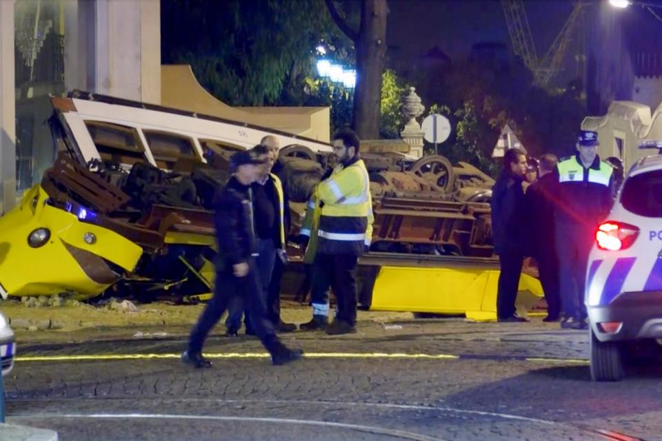 Emergency service personnel work at the scene of a tram accident (AP)