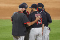 Cleveland Indians pitching coach Carl Willis, left, talks with starting pitcher Aaron Civale during the seventh inning of a baseball game against the Chicago White Sox Friday, Aug. 7, 2020, in Chicago. (AP Photo/Charles Rex Arbogast)