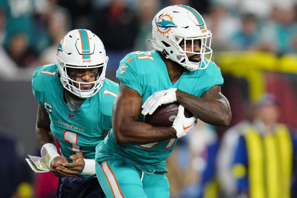 Sep 29, 2022; Cincinnati, Ohio, USA; Miami Dolphins quarterback Tua Tagovailoa (1) hands the ball off to running back Raheem Mostert (31) in the first quarter against the Cincinnati Bengals at Paycor Stadium. Mandatory Credit: Sam Greene/Cincinnati Enquirer via USA TODAY NETWORK