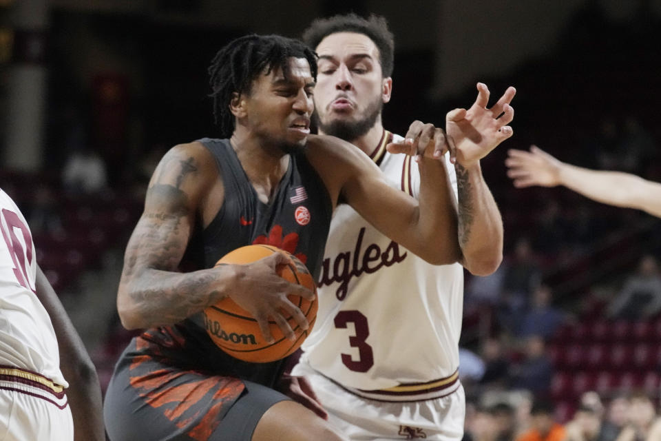 Clemson guard Dillon Hunter, left, drives to the basket against Boston College guard Jaeden Zackery (3) during the first half of an NCAA college basketball game, Tuesday, Jan. 31, 2023, in Boston. (AP Photo/Charles Krupa)