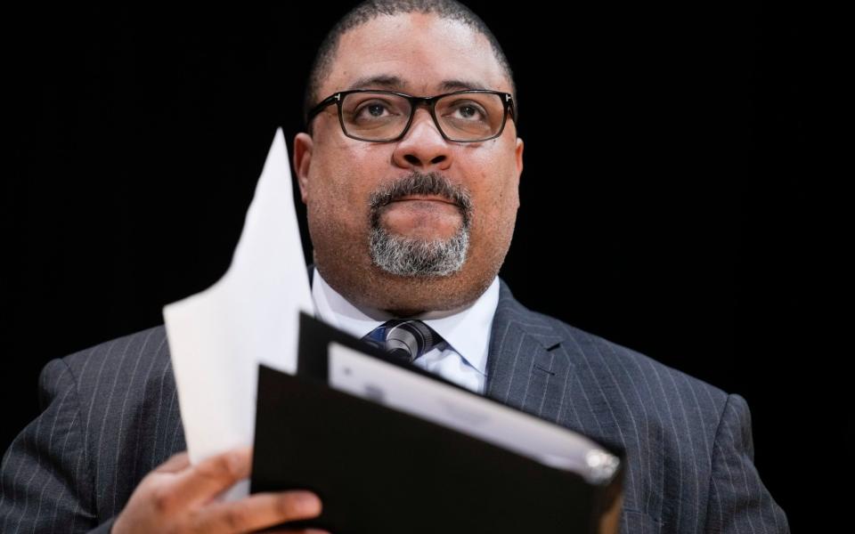 Manhattan District Attorney Alvin Bragg listens at news conference in New York - AP