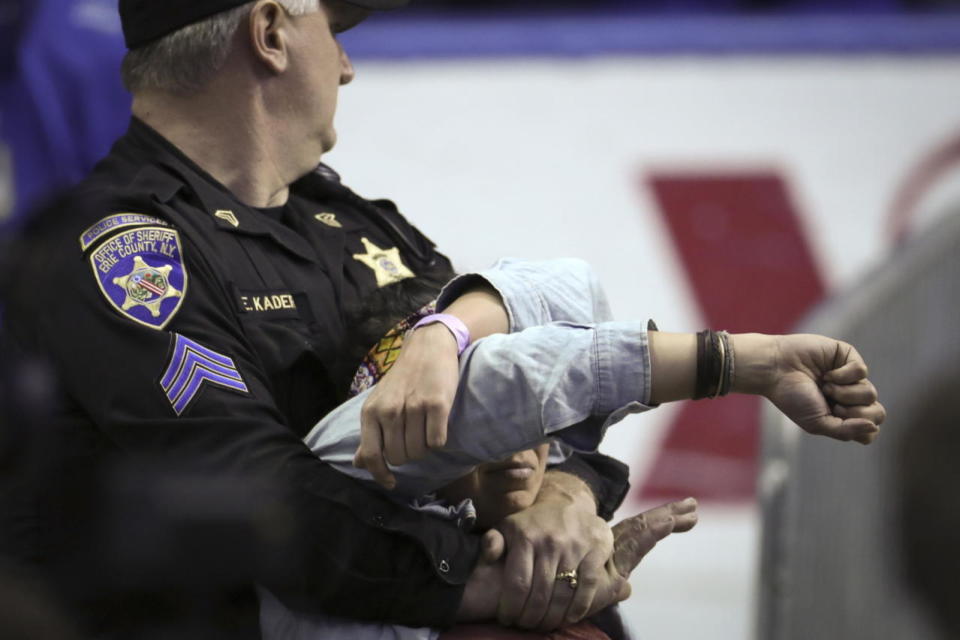 A protester is removed