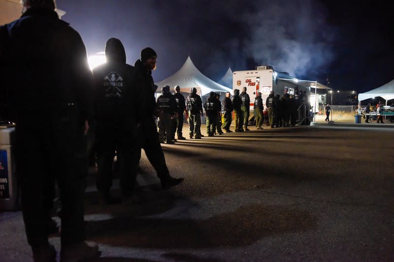 Firemen get dinner at the Cal Fire basecamp Mobile Kitchen Unit after a shift fighting the Kincaid Fire in Santa Rosa