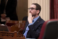 State Sen. Scott Wiener, D-San Francisco, chairman of the Senate Budget and Fiscal Review Committee, watches as the Senate votes on measure to reduce the state budget deficit at the Capitol in Sacramento, Calif., Thursday,, April 11, 2024. Both houses approved the bill that takes a number of steps to reduce the state budget deficit by about $17 billion. Gov. Gavin Newsom has said the deficit is about $38 billion.(AP Photo/Rich Pedroncelli)
