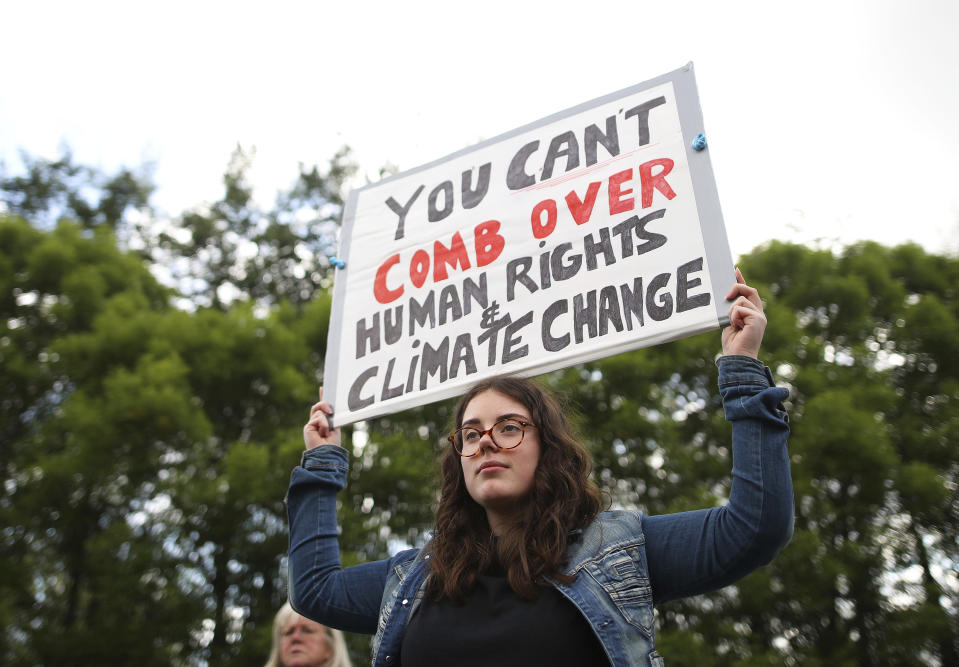 A demonstrator protests before the arrival of U.S President Trump at Shannon Airport in the west of Ireland, Wednesday, June 5, 2019. President Trump is staying overnight in Ireland before attending 75th anniversary of the D-Day landings events in northern France Thursday. (AP Photo/Peter Morrison)