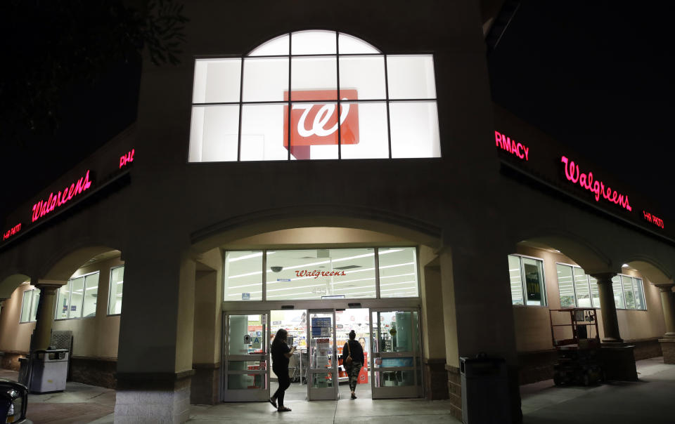 FILE - In this June 24, 2019 file photo, shoppers enter a Walgreens store in Los Angeles. Pharmacy chains, including Walgreens, are fighting claims that they're to blame for the opioid crisis in two Ohio counties. The Monday, Jan. 6, 2020, filings asked U.S. district Court Judge Dan Polster to find in the pharmacies' favor and reject claims brought by Summit and Cuyahoga counties, home to Akron and Cleveland respectively, that argue that chains such as CVS, Rite Aid and Walgreens contributed to the problem by filling an “excessive volume" of opioid prescriptions. (AP Photo/Marcio Jose Sanchez, File)