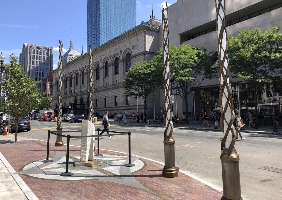 Light spires and one of the stone pillars stand along Boylston Street after installation was finished, Monday, Aug. 19, 2019, in Boston to memorialize the Boston Marathon bombing victims at the sites where they were killed. Martin Richard, Krystle Campbell and Lingzi Lu were killed when bombs were detonated at two locations near the finish line on April 15, 2013. (AP Photo/Philip Marcelo)