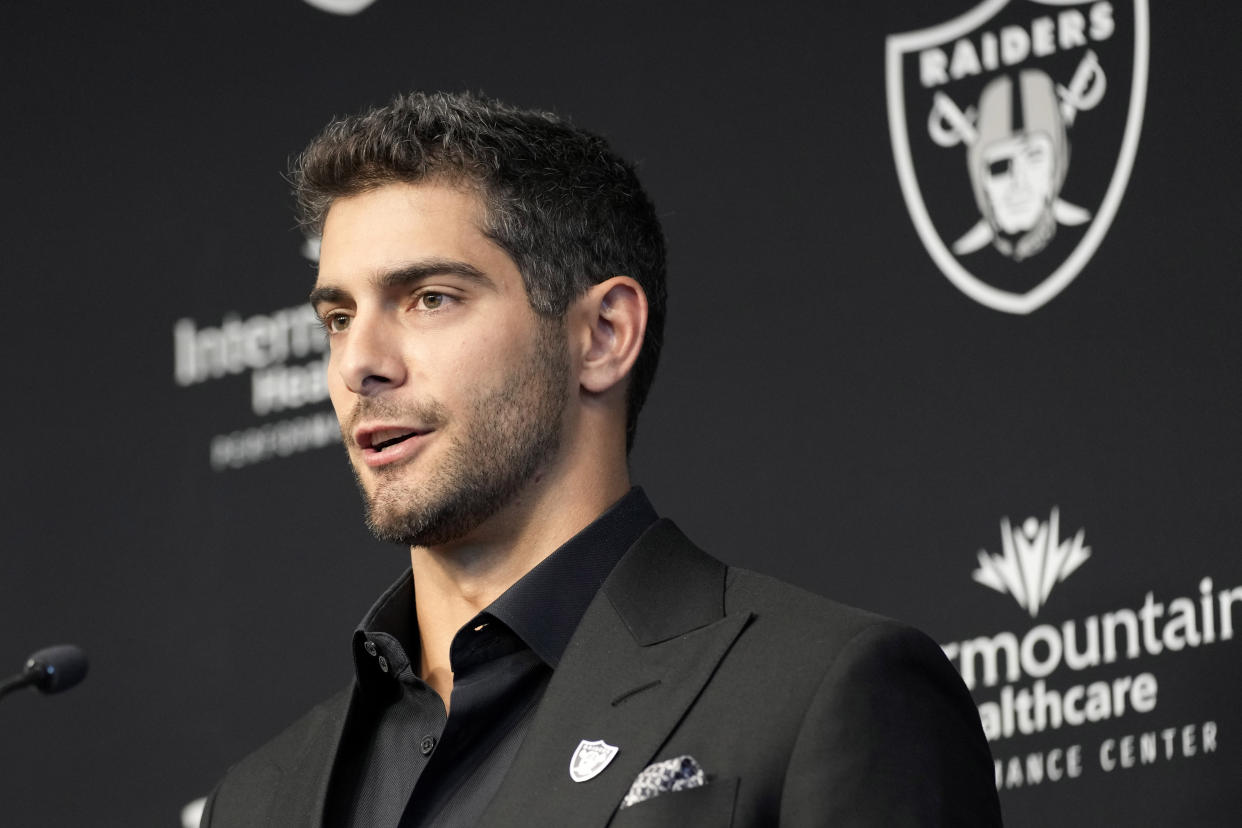 FILE - Las Vegas Raiders quarterback Jimmy Garoppolo takes questions during an NFL football news conference, Friday, March 17, 2023, in Henderson, Nev. The new Raiders quarterback is not taking part in organized team activities because of a lingering foot injury. Coach Josh McDaniels said Thursday, May 25, 2023, that Garoppolo could be held out until July when training camp begins. (AP Photo/John Locher, File)