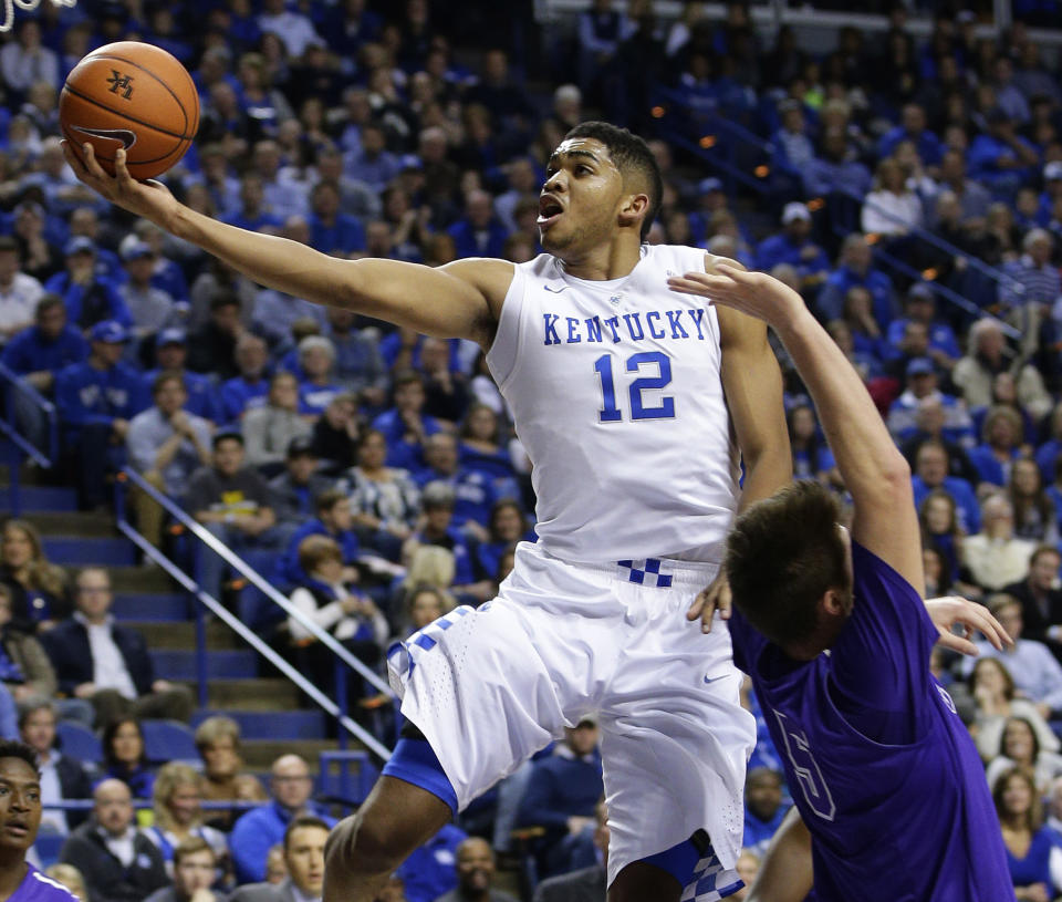 FILE - Kentucky's Karl-Anthony Towns (12) shoots next to Grand Canyon's Matt Jackson, right, and during the first half of an NCAA college basketball game, Friday, Nov. 14, 2014, in Lexington, Ky. (AP Photo/James Crisp, File)