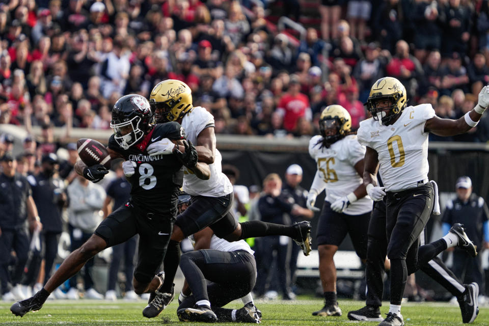 UC's wide receiver Xzavier Henderson (8) gets taken down by UCF's defense during the UC vs. UCF game at Nippert Stadium on Saturday November 4, 2023