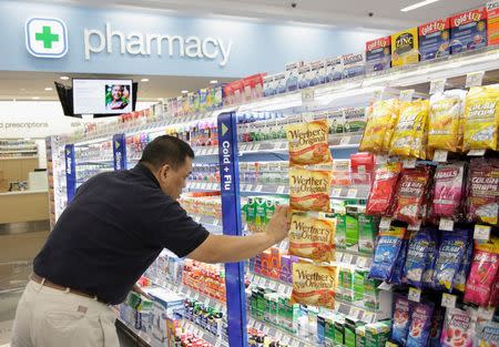 A worker stocks a new Walgreens store in Chicago, Illinois in this January 9, 2012 file photo. North Dakota's oil boom has fueled a construction bonanza for new supermarkets, restaurants and clothing stores. REUTERS/John Gress/Files