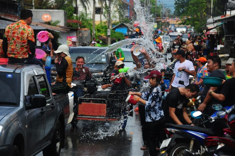 People take part in a water fight during Songkran, or Thai New Year, celebrations in the southern province of Narathiwat, on April 13, 2017