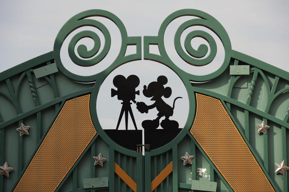 FILE - In this Sunday, June 8, 2018 file photo, a Mickey Mouse sign is displayed on the gate of the first Avengers-themed entrance at Disneyland Paris, in Chessy, France, east of Paris. The French tourist industry received a further boost Wednesday, July 15, 2020 with the partial reopening of Disneyland Paris and the opening up of the top floor of the Eiffel Tower. Disneyland Paris, Europe’s most frequented theme park resort, is partially re-opening to the public, four months after it closed as a result of the coronavirus pandemic. (AP Photo/Francois Mori, File)