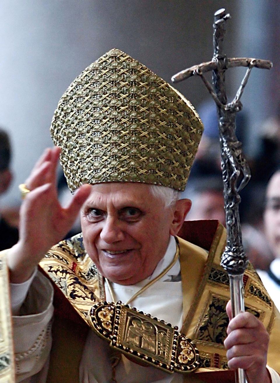 FILE - Pope Benedict XVI blesses faithful as he arrives at St. Paul's Basilica, in Rome, on Jan. 25, 2006, to preside over a Vespers Mass. When Cardinal Joseph Ratzinger became Pope Benedict XVI and was thrust into the footsteps of his beloved and charismatic predecessor, he said he felt a guillotine had come down on him. The Vatican announced Saturday Dec. 31, 2022 that Benedict, the former Joseph Ratzinger, had died at age 95. (AP Photo/Gregorio Borgia, File)