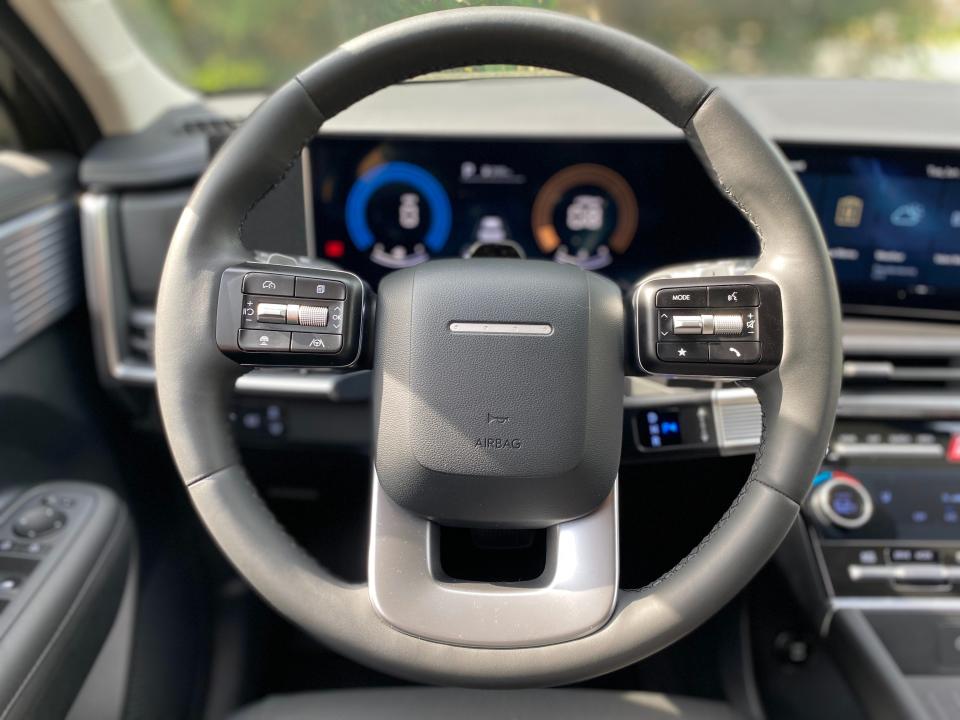 The steering wheel of a 2024 Hyundai Santa Fe SUV.