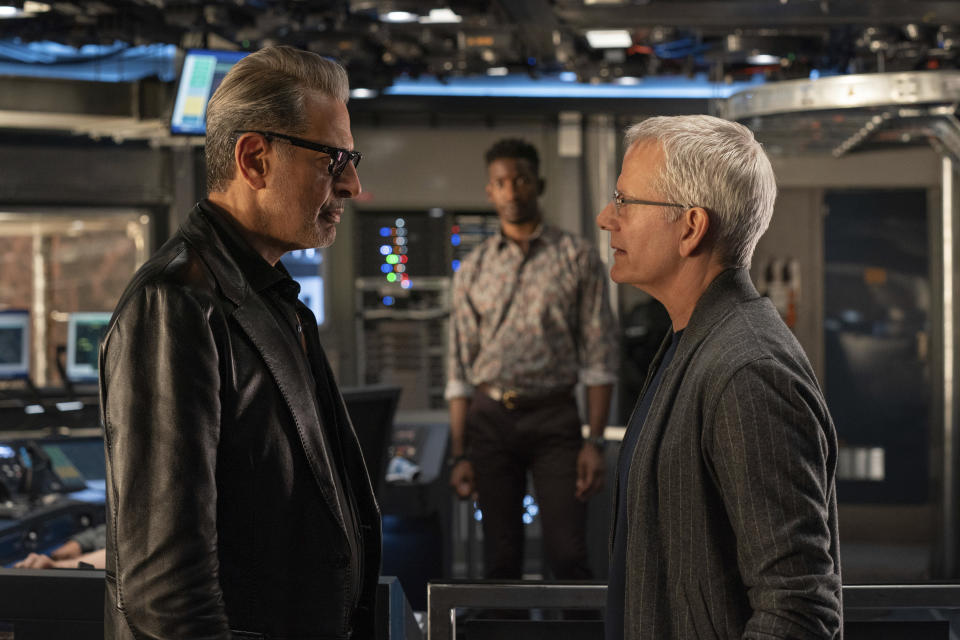 This image released by Universal Pictures shows Jeff Goldblum as Dr. Ian Malcolm, left, and, Campbell Scott as Lewis Dodgson in a scene from "Jurassic World Dominion." Scott portrays a biotech company CEO responsible for unleashing a genetically enhanced breed of grasshopper that devastates crops. (John Wilson/Universal Pictures via AP)