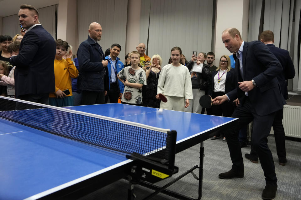 Britain's Prince William plays a game of table tennis as he visits an accommodation centre, for Ukrainians who fled the war, in Warsaw, Poland, Wednesday, March 22, 2023. (AP Photo/Czarek Sokolowski)