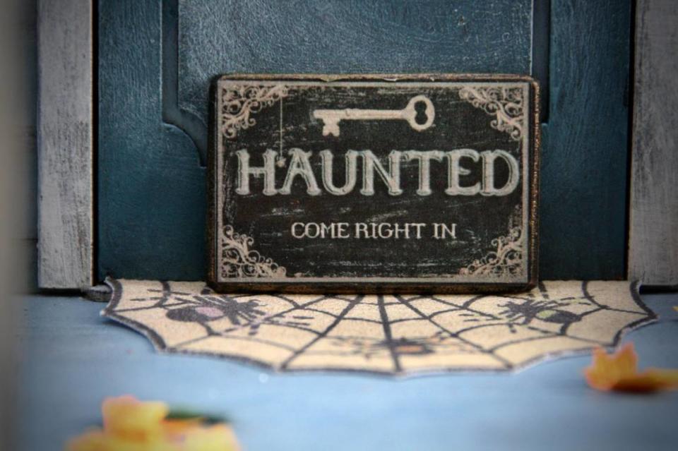 “Haunted” sign outside of a door.