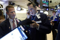 Trader Robert Charmak, left, and Gregory Rowe work on the floor of the New York Stock Exchange, Tuesday, Nov. 12, 2019. Stocks are opening slightly higher on Wall Street, led by gains in technology and health care companies. (AP Photo/Richard Drew)