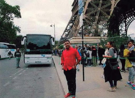 An alleged member of the Islamist cell suspected of carrying out last year's jihadists attacks in Catalonia poses next to the Eiffel Tower