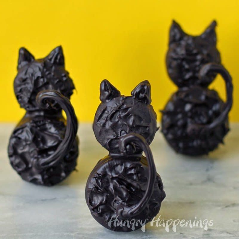 <p>Dip cookies into dark chocolate or black candy melts to create these adorable black cat cookies for Halloween or a cat-themed party. These sweet treats are delicious and fun!</p><p>Get the recipe: <a href="https://hungryhappenings.com/backside-black-cat-cookies-Halloween-recipe/" rel="nofollow noopener" target="_blank" data-ylk="slk:Backside Black Cat Cookies;elm:context_link;itc:0;sec:content-canvas" class="link ">Backside Black Cat Cookies</a></p>