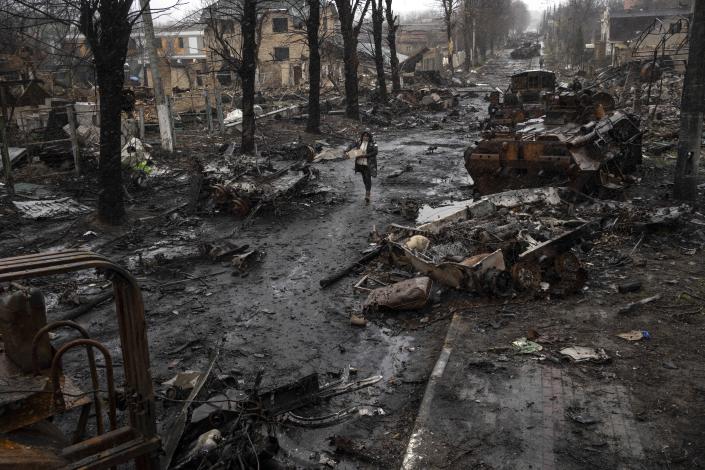 A woman walks amid the destruction on the streets of Bucha, on the outskirts of Kyiv, on April 3, 2022. (Rodrigo Abd / AP file)