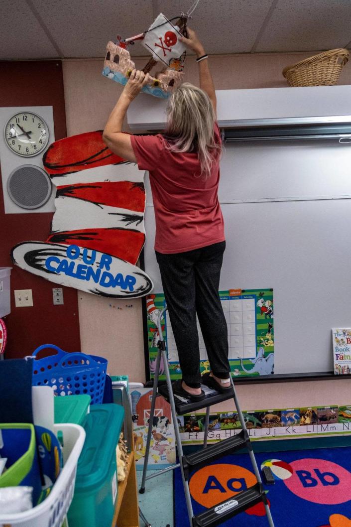 Denise Soufrine decorates her kindergarten classroom as she prepares for the upcoming school year at Pembroke Pines Elementary in South Florida. Classes for Broward County public school students start Tuesday, Aug. 16.