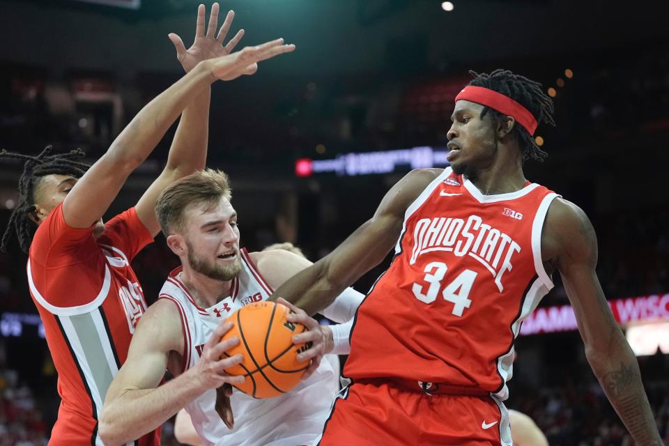 Wisconsin's Tyler Wahl is fouled by Ohio State's Felix Okpara during the second half of an NCAA college basketball game Tuesday, Feb. 13, 2024, in Madison, Wis. (AP Photo/Morry Gash)