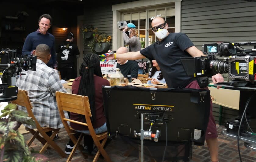 Behind the scenes on the set of THE UNICORN on CBS shot in January of 2021. Pictured: Rob Corddry as Forrest, Michaela Watkins as Delia, Walton Goggins as Wade(standing), Maya Lynne Robinson as Michelle, Omar Miller as Ben. Episode: "Out with the Old" – Wade, Forrest and Ben decide to schedule colonoscopy appointments at the same time after they learn that Ben is scared to go. Also, Michelle tries to avoid her sister Meg's (Nicole Byer) boyfriend drama, but Delia winds up getting over-involved in Meg's issues, on THE UNICORN, Thursday, March 11 (9:30-10:00 PM, ET/PT) on the CBS Television Network. Photo: Patrick Wymore/CBS ©2021 CBS Broadcasting, Inc. All Rights Reserved.