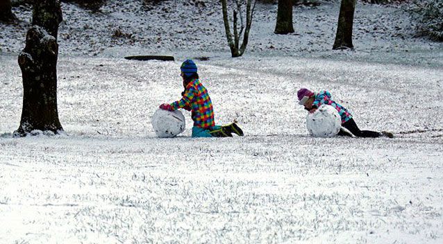 Children roll snowballs in a park after snow fell in the town of Mount Victoria, west of Sydney, in a 2016 cold snap. Source: Reuters.