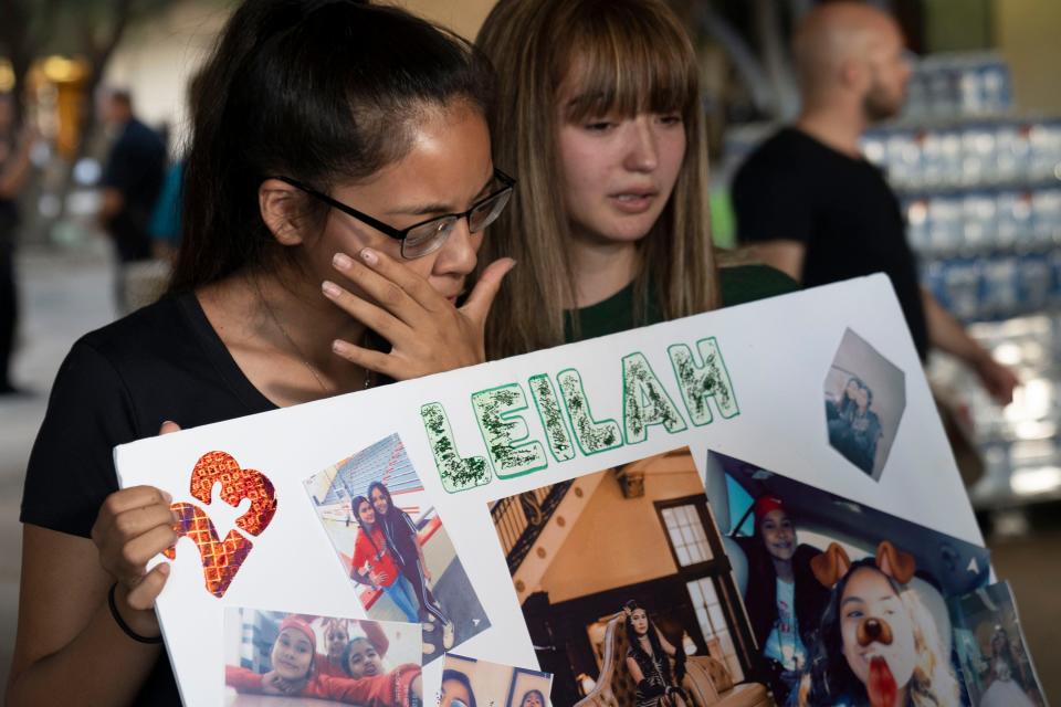 Yasmin Natera 16, left, and Celeste Lujan, 15, cries for one of their friends, a victim in a mass shooting in Odessa. The community came together at the University of Texas for a prayer vigil.