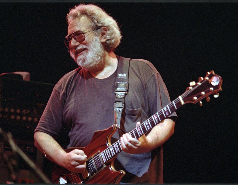 FILE - Grateful Dead lead singer Jerry Garcia performs at the Oakland , Calif., Coliseum on Nov. 1, 1992. The band has broken the record for the most Top 40 albums to chart on the Billboard 200. The Grateful Dead pulled out ahead of Elvis Presley and Frank Sinatra with 59 total Top 40 entries on the chart Monday following the No. 25 debut of their archival release “Dave’s Picks, Volume 49: Frost Amphitheatre, Stanford U., Palo Alto, CA (4/27/85 & 4/28/85).” (AP Photo/Kristy McDonald, File)