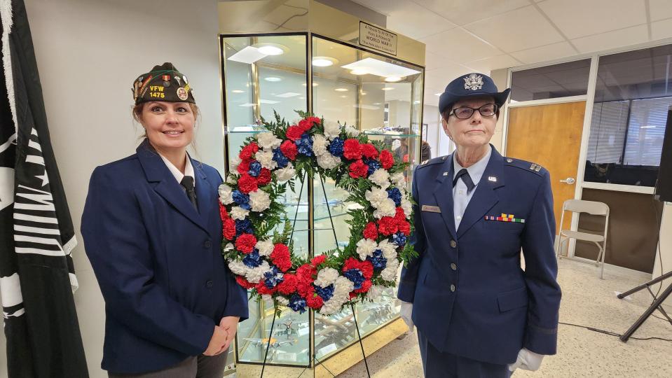 Veterans Brenna Barrett and Sunny Buchanon stand with the ceremonial wreath Friday during the Veterans Day Ceremony at the Texas Panhandle War Memorial Center.