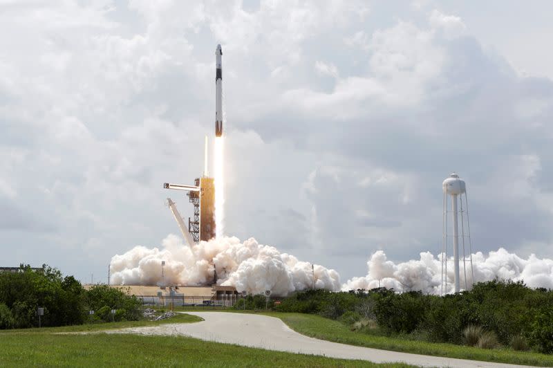 A SpaceX Falcon 9 rocket and Crew Dragon spacecraft carrying NASA astronauts Douglas Hurley and Robert Behnken lifts off