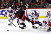 Carolina Hurricanes' Jack Drury (18) chases the puck between New York Rangers' Erik Gustafsson (56) and Barclay Goodrow (21) during the second period in Game 4 of an NHL hockey Stanley Cup second-round playoff series in Raleigh, N.C., Saturday, May 11, 2024. (AP Photo/Karl B DeBlaker)