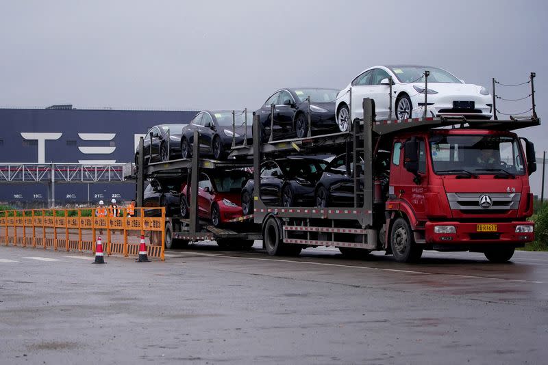 FILE PHOTO: A truck transports new Tesla cars at its factory in Shanghai